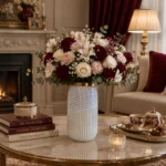 گلدان شیشه‌ای دکوراتیو رومیزی مدل کاترین سایز 30؛ ترکیبی از طراحی مدرن و ظرافت هنرمندانه اگر به دنبال یک گلدان خاص و متفاوت برای تکمیل دکوراسیون منزل یا محل کار خود هستید، گلدان شیشه‌ای دکوراتیو رومیزی مدل کاترین سایز 30 انتخابی ایده‌آل خواهد بود. این گلدان با طراحی استوانه‌ای کشیده، ترکیب دو نوع بافت متفاوت روی بدنه، رنگ مرواریدی درخشان و لبه طلایی براق، جلوه‌ای لوکس و مدرن به فضای شما می‌بخشد. گلدان شیشه‌ای دکوراتیو رومیزی مدل کاترین سایز 30 علاوه بر زیبایی ظاهری، با ارتفاع مناسب خود برای گل‌آرایی‌های شاخه‌ای نیز بسیار کاربردی است. طراحی منحصربه‌فرد این مدل باعث شده تا حتی بدون قرار گرفتن گل، به‌عنوان یک اکسسوری دکوراتیو مستقل نیز جلوه‌ای چشمگیر داشته باشد. طراحی گلدان شیشه‌ای دکوراتیو رومیزی مدل کاترین سایز 30 یکی از مهم‌ترین ویژگی‌های گلدان شیشه‌ای دکوراتیو رومیزی مدل کاترین سایز 30، طراحی متفاوت بدنه آن است. بخش پایینی گلدان با شیارهای عمودی منظم طراحی شده که حس نظم و ظرافت را به نمایش می‌گذارد، در حالی که قسمت بالایی با خطوط مارپیچی برجسته، جلوه‌ای پویا و مدرن ایجاد کرده است. ترکیب این دو نوع بافت در کنار رنگ مرواریدی براق، باعث می‌شود نور در زوایای مختلف به زیبایی روی سطح گلدان منعکس شود و درخشش خاصی به آن ببخشد. لبه طلایی صیقلی نیز هماهنگی زیبایی با بدنه ایجاد کرده و ظاهر لوکس این محصول را کامل می‌کند. ابعاد گلدان شیشه‌ای دکوراتیو رومیزی مدل کاترین سایز 30 گلدان شیشه‌ای دکوراتیو رومیزی مدل کاترین سایز 30 با ابعاد استاندارد و کاربردی طراحی شده است و برای استفاده در بخش‌های مختلف منزل یا محیط کار مناسب است. مشخصات این محصول عبارت‌اند از: ارتفاع: 30 سانتی‌متر قطر دهانه: 8 سانتی‌متر ارتفاع مناسب این گلدان باعث شده برای گل‌های شاخه‌ای بلند و چیدمان‌های دکوراتیو انتخابی ایده‌آل باشد. کاربرد گلدان شیشه‌ای دکوراتیو رومیزی مدل کاترین سایز 30 در گل‌آرایی گلدان شیشه‌ای دکوراتیو رومیزی مدل کاترین سایز 30 برای انواع گل‌آرایی طراحی شده و می‌تواند زیبایی گل‌ها را چندین برابر کند. این گلدان برای استفاده با موارد زیر مناسب است: گل‌های طبیعی گل‌های مصنوعی گل‌های خشک پامپاس اکالیپتوس شاخه‌های بلند تزئینی برگ‌های دکوراتیو گل‌های فصلی فرم استوانه‌ای و کشیده این مدل باعث می‌شود شاخه‌های گل به‌صورت منظم قرار گرفته و جلوه‌ای حرفه‌ای و زیبا ایجاد کنند. گلدان شیشه‌ای دکوراتیو رومیزی مدل کاترین سایز 30 مناسب چه دکوراسیونی است؟ به دلیل طراحی مدرن و رنگ خنثی، گلدان شیشه‌ای دکوراتیو رومیزی مدل کاترین سایز 30 با سبک‌های مختلف دکوراسیون هماهنگ می‌شود. این گلدان برای فضاهای زیر انتخابی مناسب است: دکوراسیون مدرن دکوراسیون مینیمال دکوراسیون نئوکلاسیک دکوراسیون کلاسیک سبک معاصر دکوراسیون لوکس همچنین رنگ مرواریدی این محصول به‌راحتی با رنگ‌های سفید، کرم، بژ، طوسی، طلایی، چوب طبیعی و سبز زیتونی هماهنگ شده و فضایی آرام، شیک و دلنشین ایجاد می‌کند. کیفیت ساخت گلدان شیشه‌ای دکوراتیو رومیزی مدل کاترین سایز 30 در ساخت گلدان شیشه‌ای دکوراتیو رومیزی مدل کاترین سایز 30 از شیشه باکیفیت استفاده شده است که علاوه بر شفافیت و درخشندگی، دوام مناسبی نیز دارد. پرداخت دقیق شیارهای عمودی، خطوط مارپیچی و لبه طلایی نشان‌دهنده کیفیت بالای ساخت این محصول است. سطح براق گلدان نیز باعث می‌شود در نور طبیعی و مصنوعی جلوه‌ای چشمگیر داشته باشد. چرا گلدان شیشه‌ای دکوراتیو رومیزی مدل کاترین سایز 30 را انتخاب کنیم؟ اگر به دنبال یک گلدان دکوراتیو خاص و باکیفیت هستید، این مدل مزایای فراوانی دارد: طراحی مدرن با دو نوع بافت متفاوت رنگ مرواریدی درخشان و چشم‌نواز لبه طلایی براق و لوکس مناسب برای گل‌های شاخه‌ای بلند ابعاد استاندارد و کاربردی مناسب برای گل طبیعی، مصنوعی و خشک هماهنگ با انواع سبک‌های دکوراسیون کیفیت ساخت بالا مناسب برای منزل، محل کار و هدیه راهنمای نگهداری از گلدان شیشه‌ای دکوراتیو رومیزی مدل کاترین سایز 30 برای حفظ زیبایی و دوام این گلدان بهتر است نکات زیر را رعایت کنید: با آب ولرم و شوینده ملایم شسته شود. از اسکاچ زبر یا مواد شوینده قوی استفاده نشود. پس از شست‌وشو با دستمال نرم و بدون پرز خشک شود. از وارد شدن ضربه مستقیم به بدنه جلوگیری گردد. برای حفظ درخشندگی لبه طلایی، از تماس طولانی‌مدت با مواد شیمیایی خودداری شود. خرید گلدان شیشه‌ای دکوراتیو رومیزی مدل کاترین سایز 30 اگر قصد خرید یک گلدان شیشه‌ای دکوراتیو رومیزی با طراحی متفاوت، کیفیت بالا و ظاهری لوکس را دارید، گلدان شیشه‌ای دکوراتیو رومیزی مدل کاترین سایز 30 یکی از بهترین گزینه‌ها برای شما خواهد بود. طراحی خاص با ترکیب شیارهای عمودی و خطوط مارپیچی، رنگ مرواریدی درخشان و لبه طلایی، این گلدان را به محصولی منحصربه‌فرد برای دکوراسیون منزل، محل کار و فضاهای تجاری تبدیل کرده است. این مدل علاوه بر کاربرد در گل‌آرایی، به‌تنهایی نیز یک اکسسوری دکوراتیو ارزشمند محسوب می‌شود و می‌تواند جلوه‌ای مدرن و لوکس به فضای شما ببخشد. اگر به دنبال محصولی زیبا، باکیفیت و ماندگار هستید، گلدان شیشه‌ای دکوراتیو رومیزی مدل کاترین سایز 30 انتخابی هوشمندانه برای تکمیل دکوراسیون شما خواهد بود.